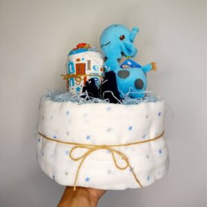 Front view of 1 tier nappy cake with blue giraffe on the top.
